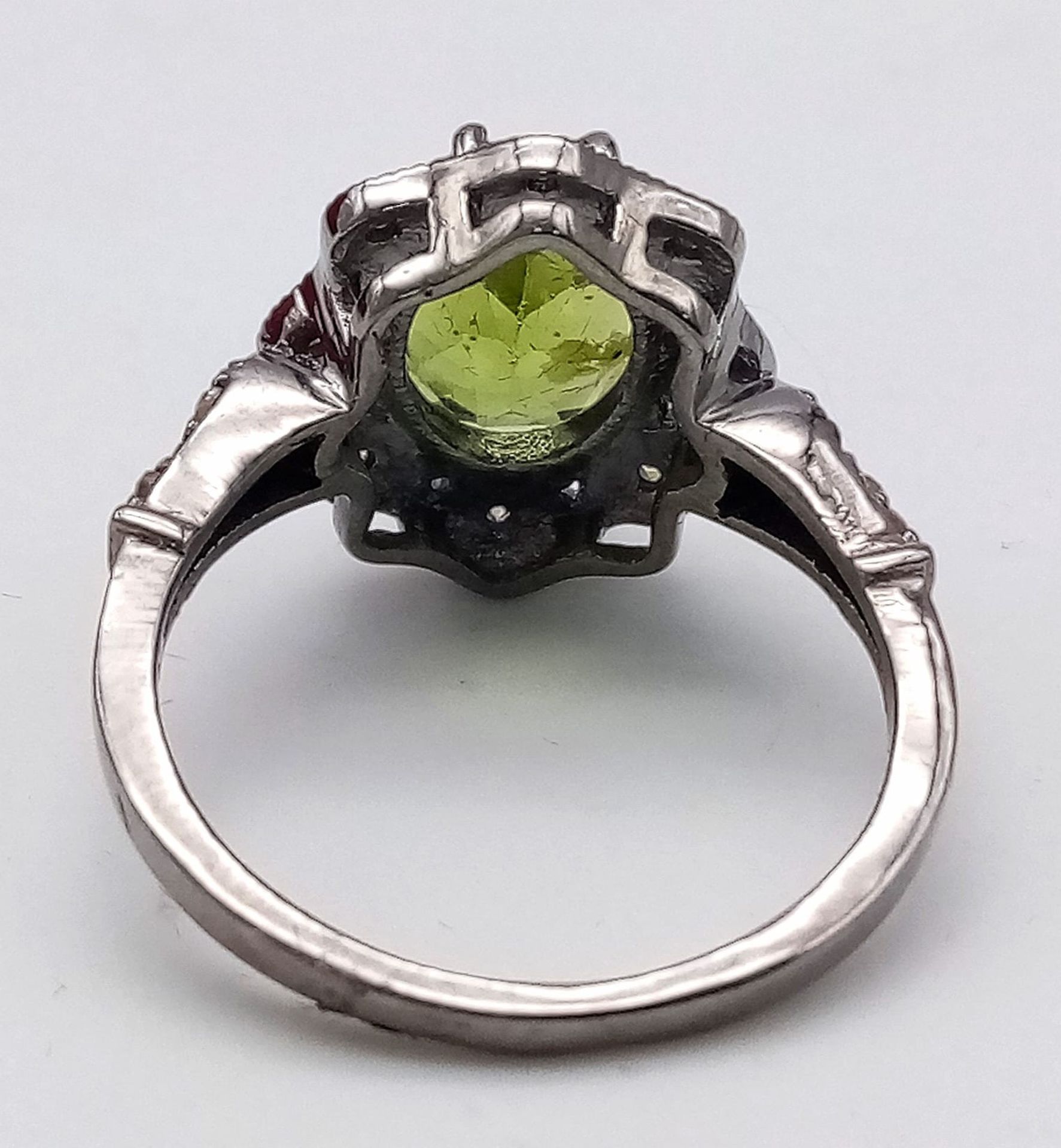 A Peridot and Diamond 925 Silver Ring. Central 2.50ct oval peridot with a diamond surround - 0. - Image 3 of 6