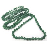 A superb, long beaded Jade necklace. Measuring 124 cm in length, with rich, deep, mesmerising