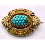 An ornate, Antique Mid-Carat Gold Brooch with Turquoise centre. Elaborate frame with Art Deco