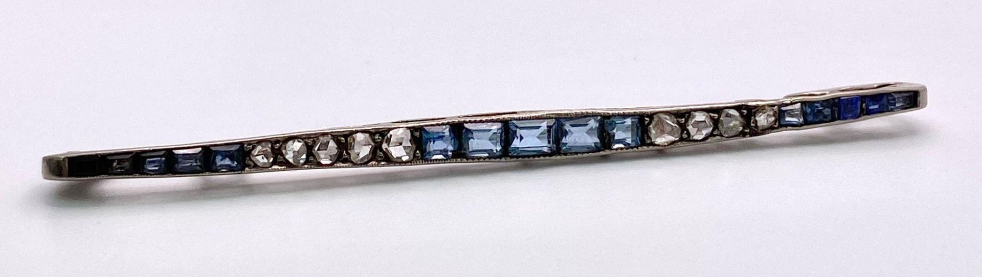 An 18kt White Gold Brooch set with Topaz, Diamond & Aquamarine Stones. Comes in used condition,