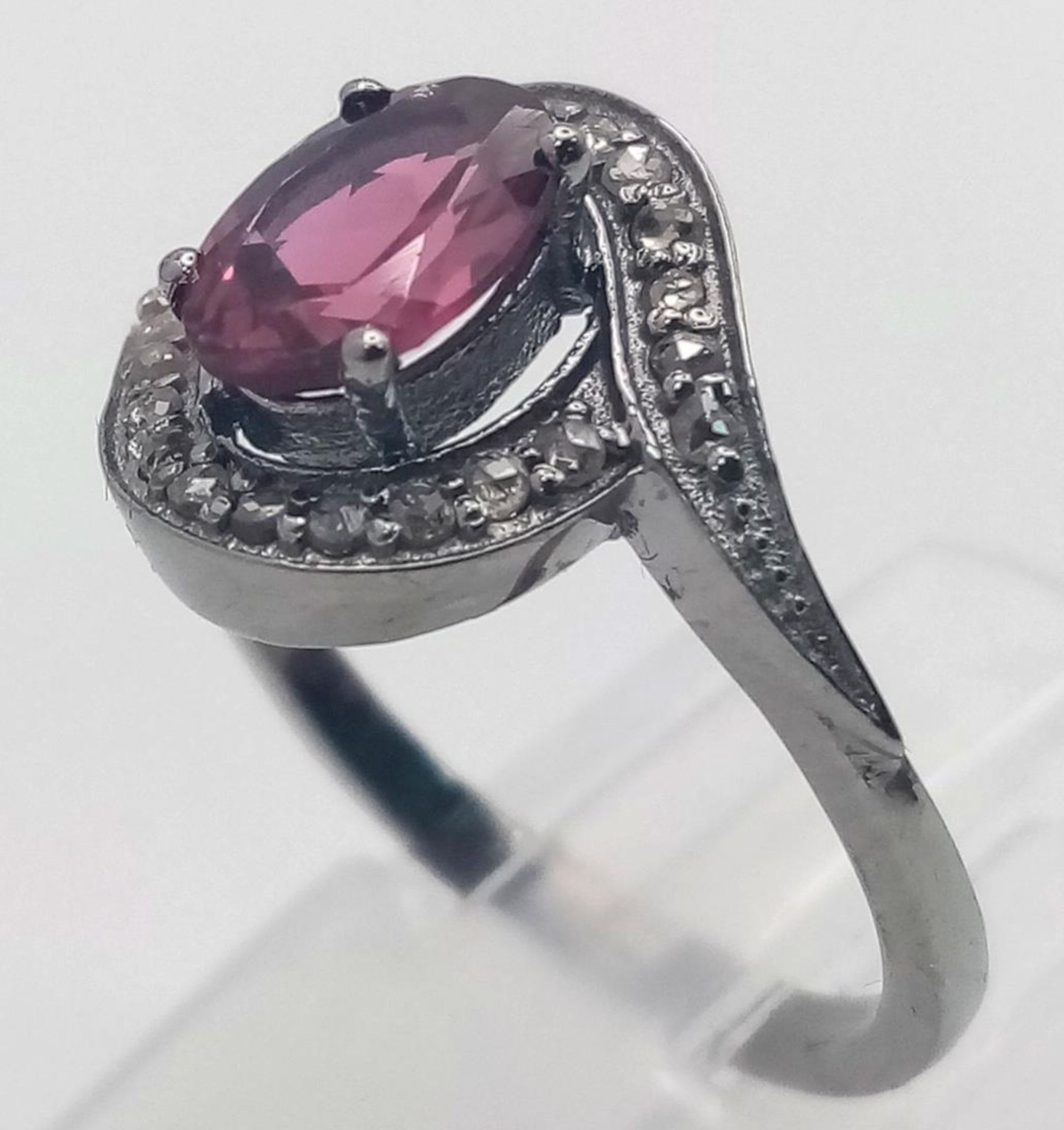 A Garnet and Diamond Ring set in 925 Silver with a Black Rhodium coating. Oval cut Garnet- 0.80ct. - Image 3 of 7