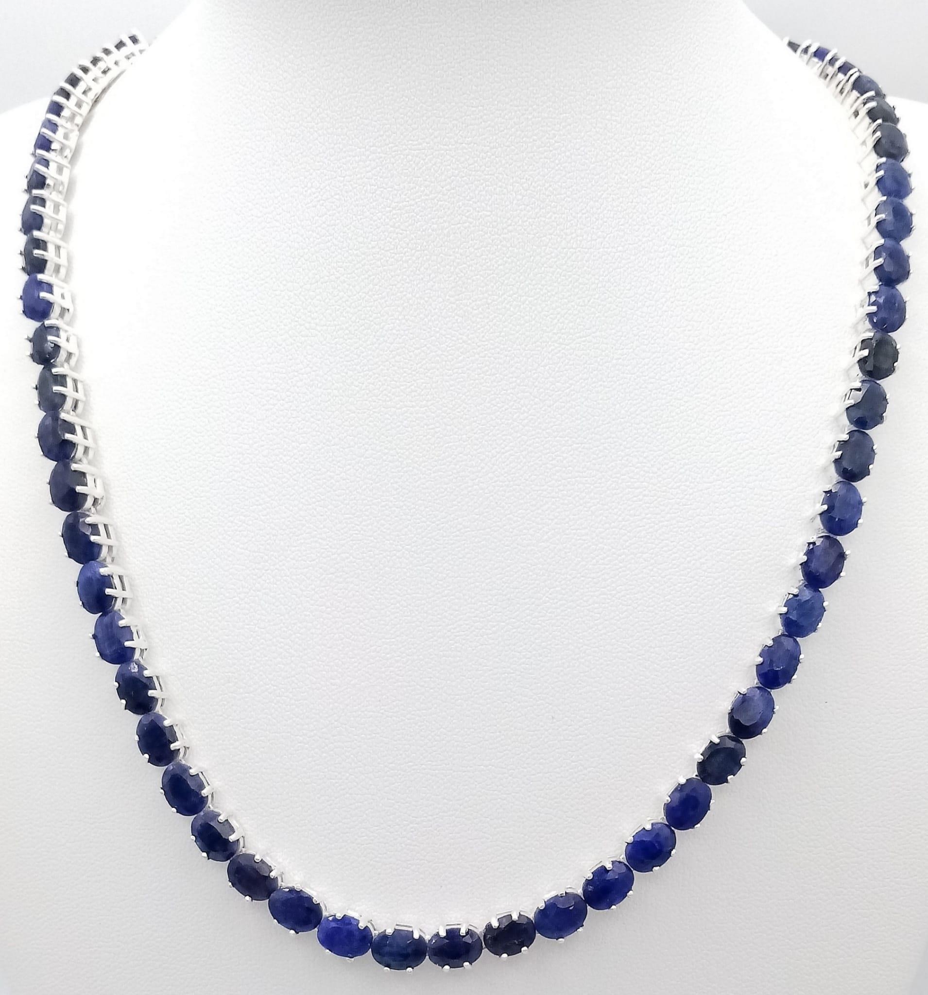 A Blue Sapphire Gemstone Tennis Necklace set in 925 Silver. 45cm length. 39.7g total weight. CD-1229