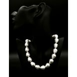 A Large White Baroque Shaped Pearl Shell Necklace. 42cm.