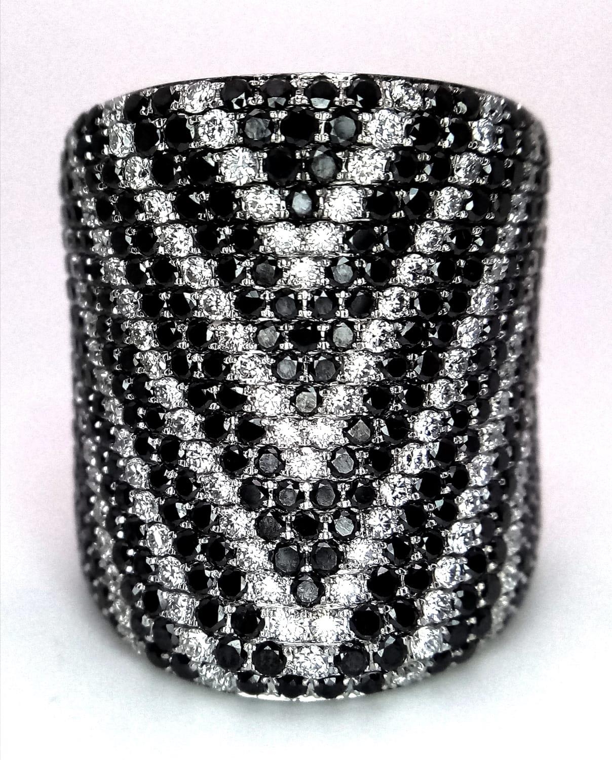 An Incredible Black and White Diamond 18K Gold Dress Ring. This cylindrical masterpiece has over 200