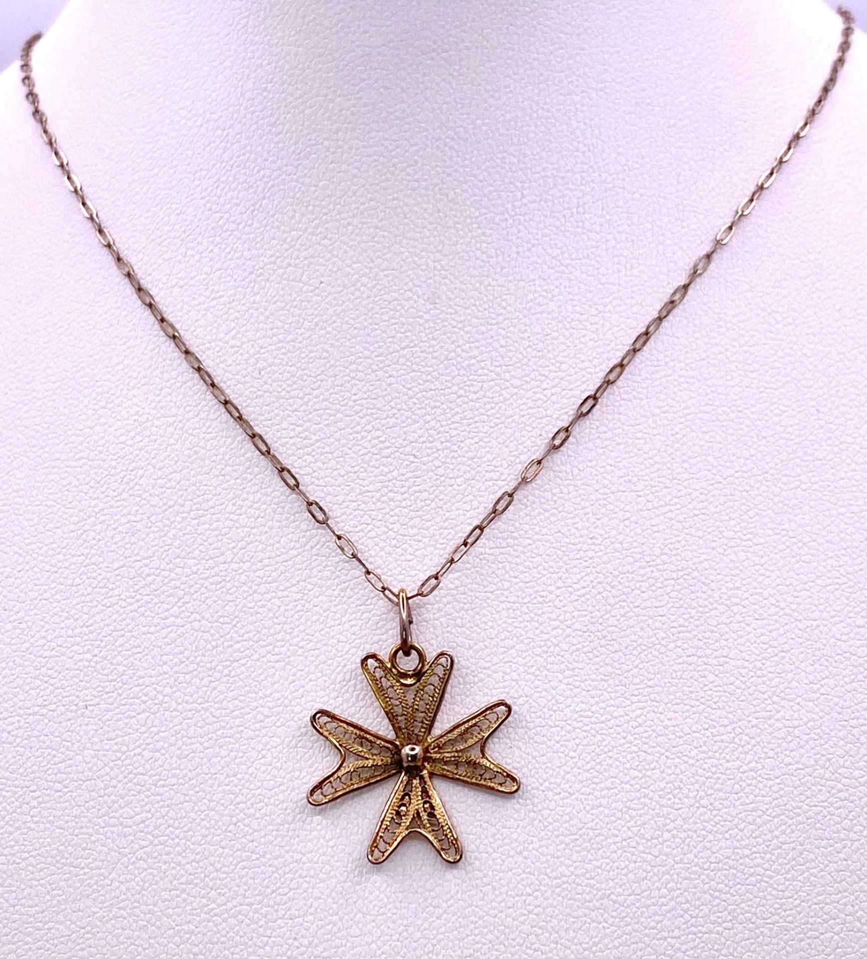 A 925 gilded silver Filigree Maltese cross pendant on silver chain. Total weight 2G. Total length