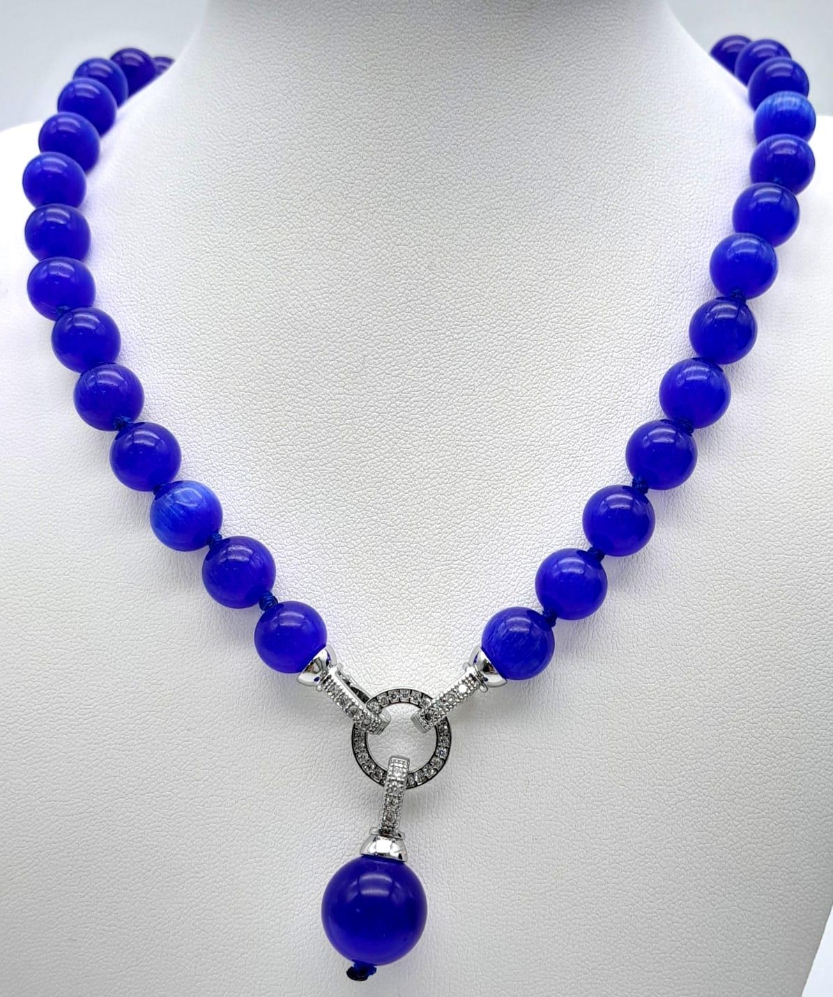 A Blue Cats Eye Bead Necklace with Hanging Pendant. 10mm and 14mm beads. 42cm necklace length.