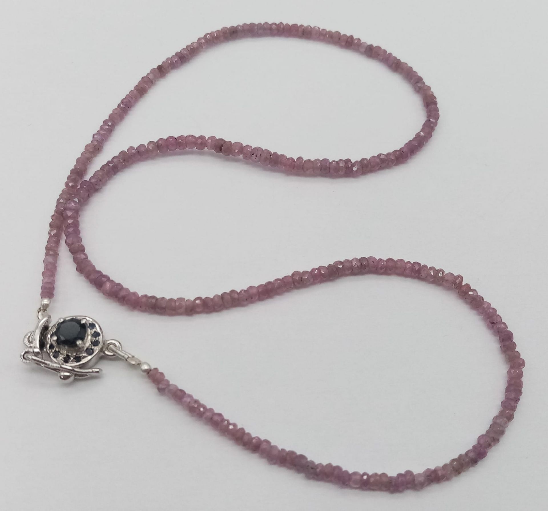 A Single Strand Pink Sapphire Necklace with Ruby and 925 Silver Clasp. 42cm length.