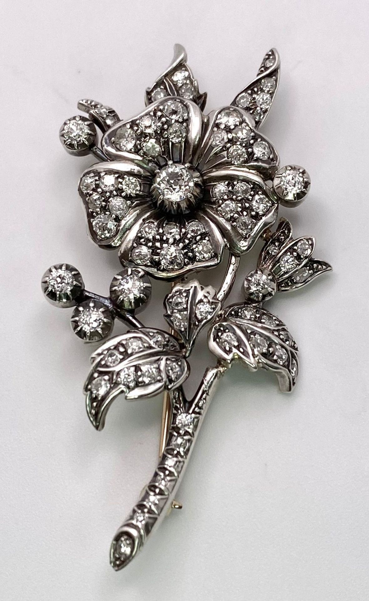 An Antique 18K Gold and Diamond Floral Brooch. This beautifully constructed masterpiece has a - Image 2 of 7