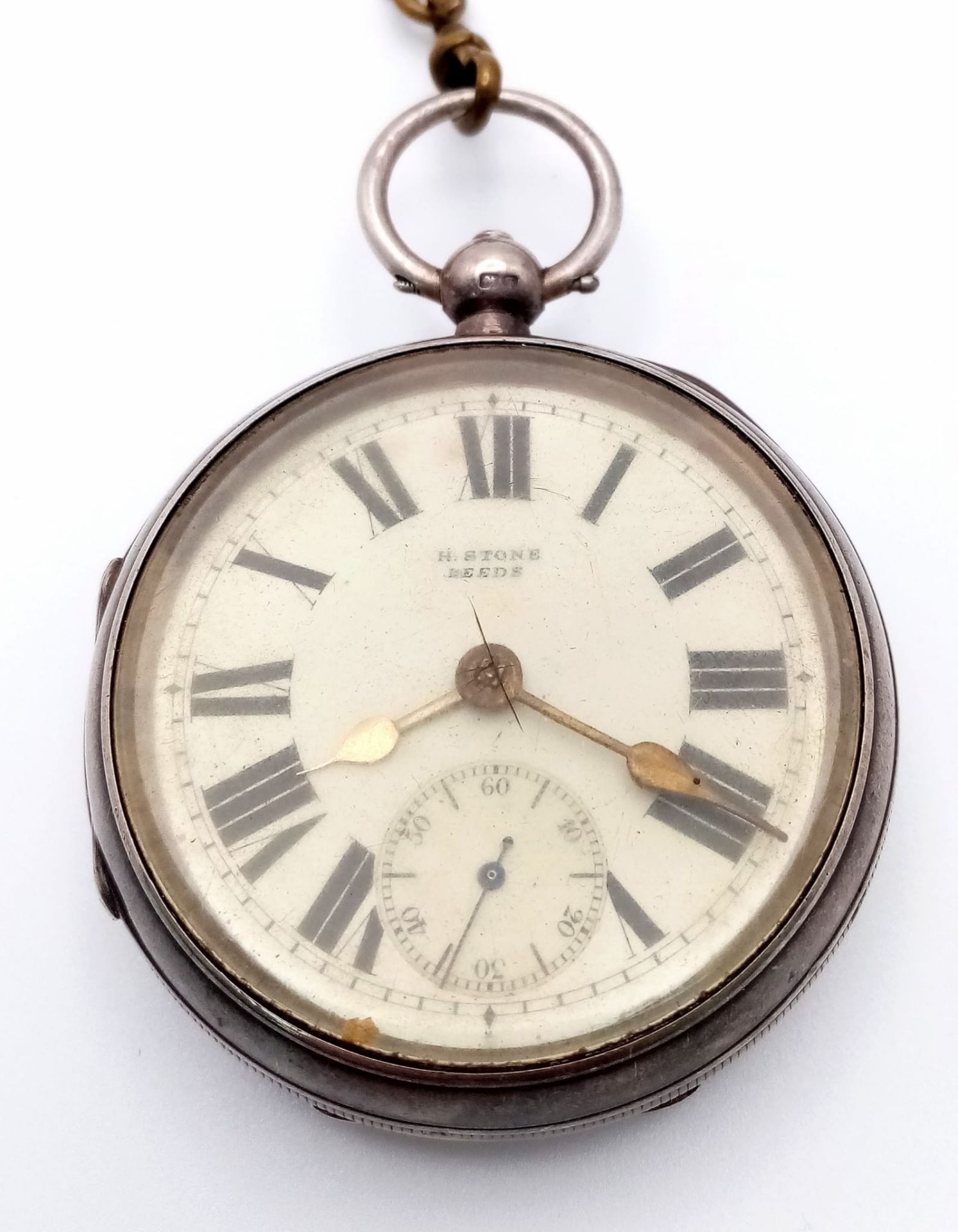 An Antique Sterling Silver H.Stone of Leeds Pocket Watch. Open face with a white dial and sub