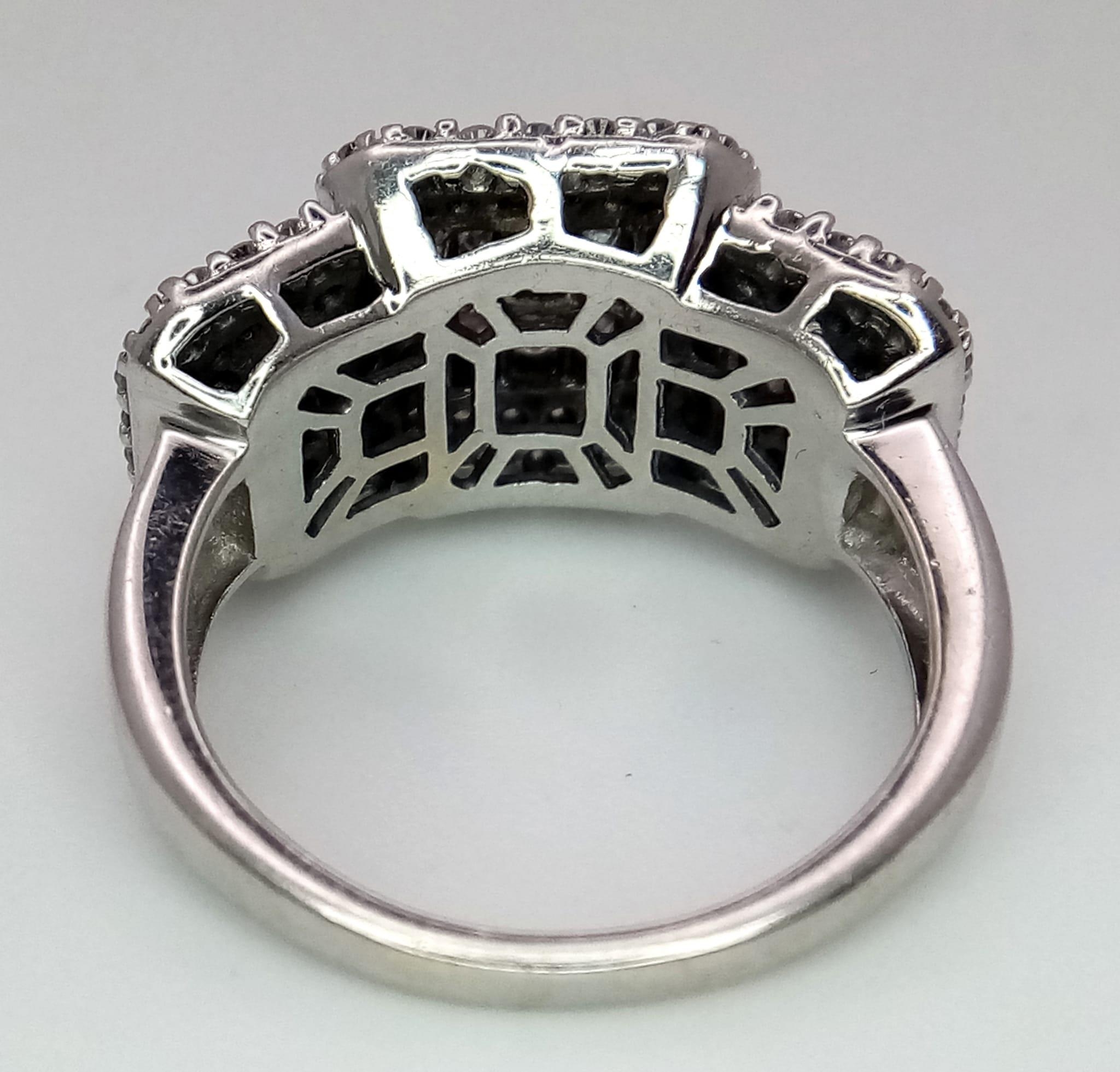 An Art Deco Style 18K White Gold and Diamond Ring. A belt-buckle design of round and princess cut - Image 6 of 7