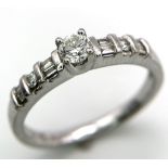18kt White Gold, Diamond Ring. Centre Stone, 0.30ct Round Cut Diamond, is accented by shoulder