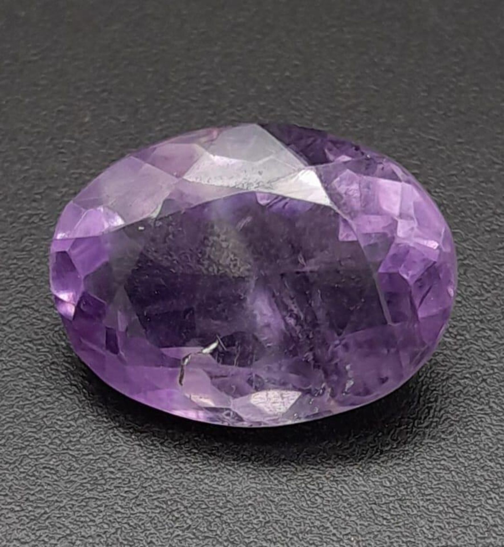 A 7.44ct Amethyst Loose Gemstone in Oval shape. Brazil Origin. GFCO Swiss Certified.