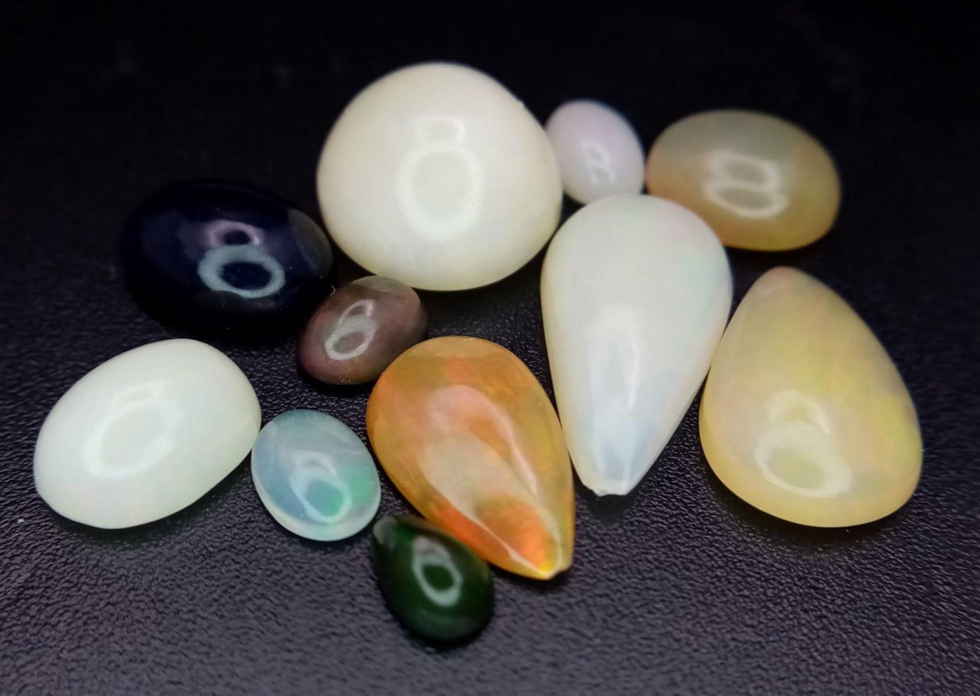 An 11ctw Lot of Ethiopian Opals. 11 stones in a clip-open case.