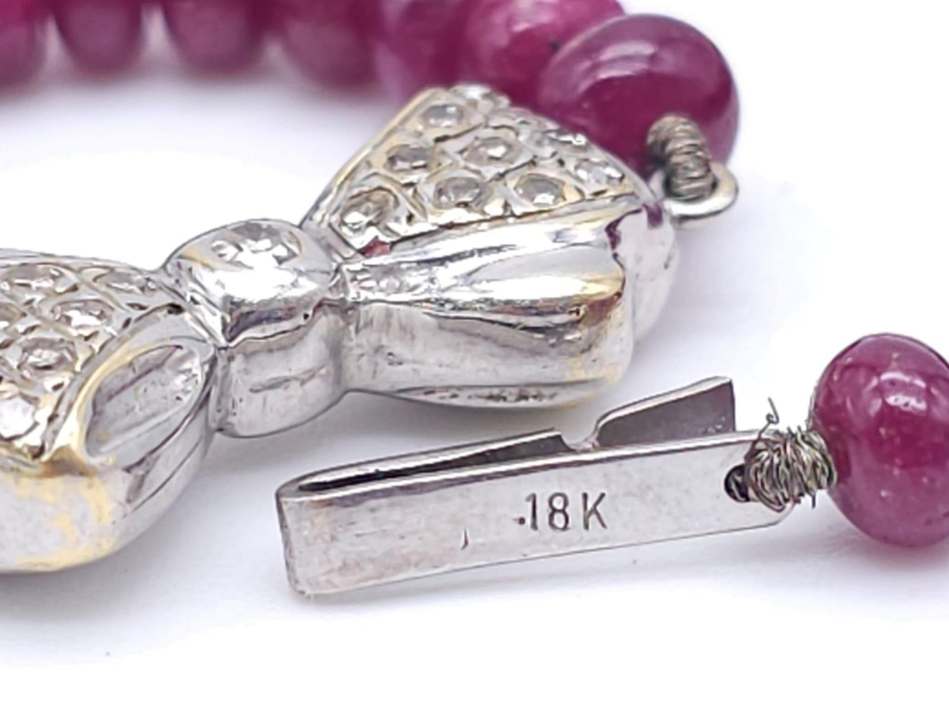 A superb graduating Ruby Red Stone Beaded Necklace with a 18kt White Gold, Diamond Set Bow Clasp. - Image 6 of 7