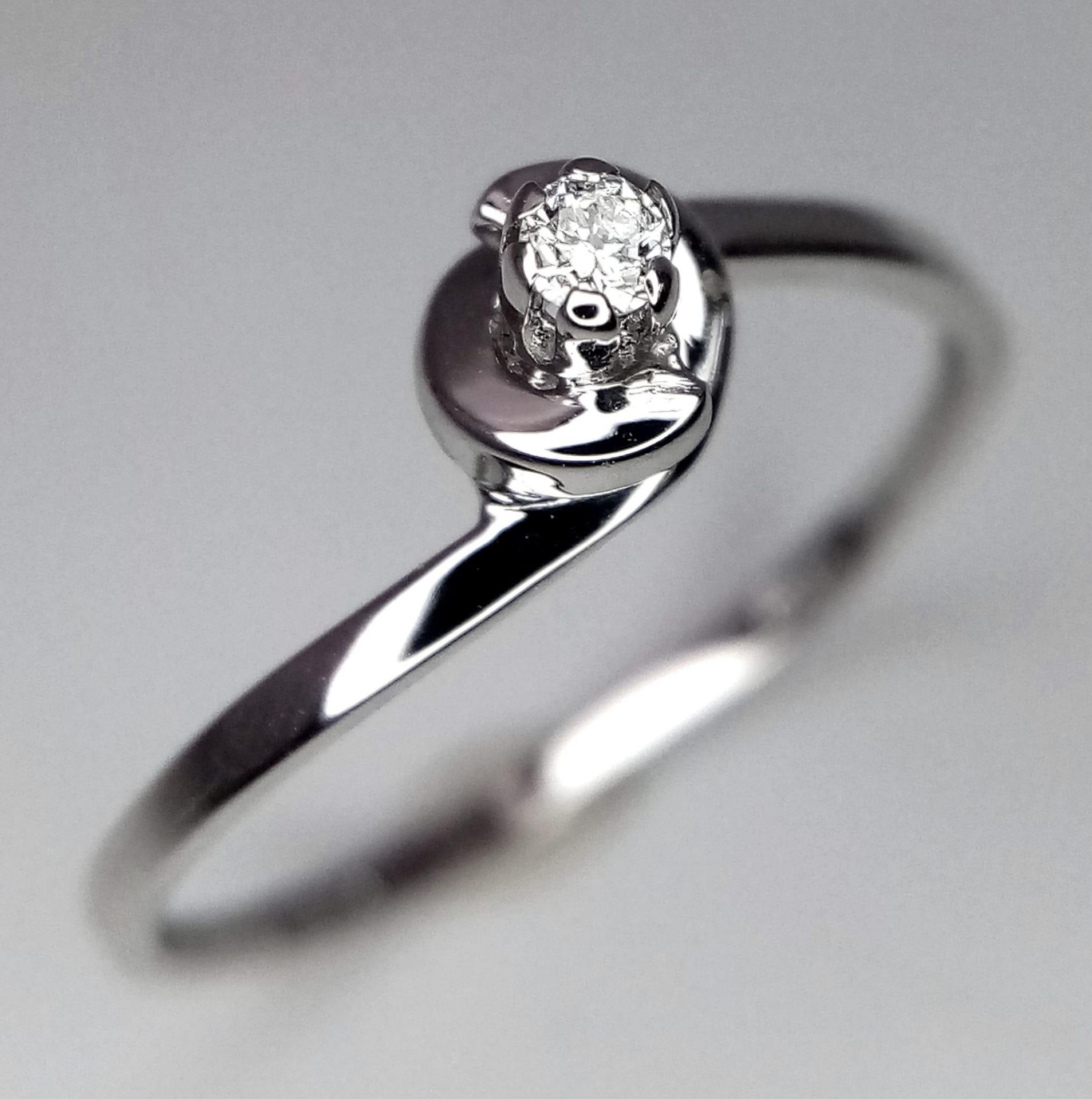 An 18K White Gold Diamond Solitaire Ring. Size N. 1.15g total weight. Brilliant round cut diamond.