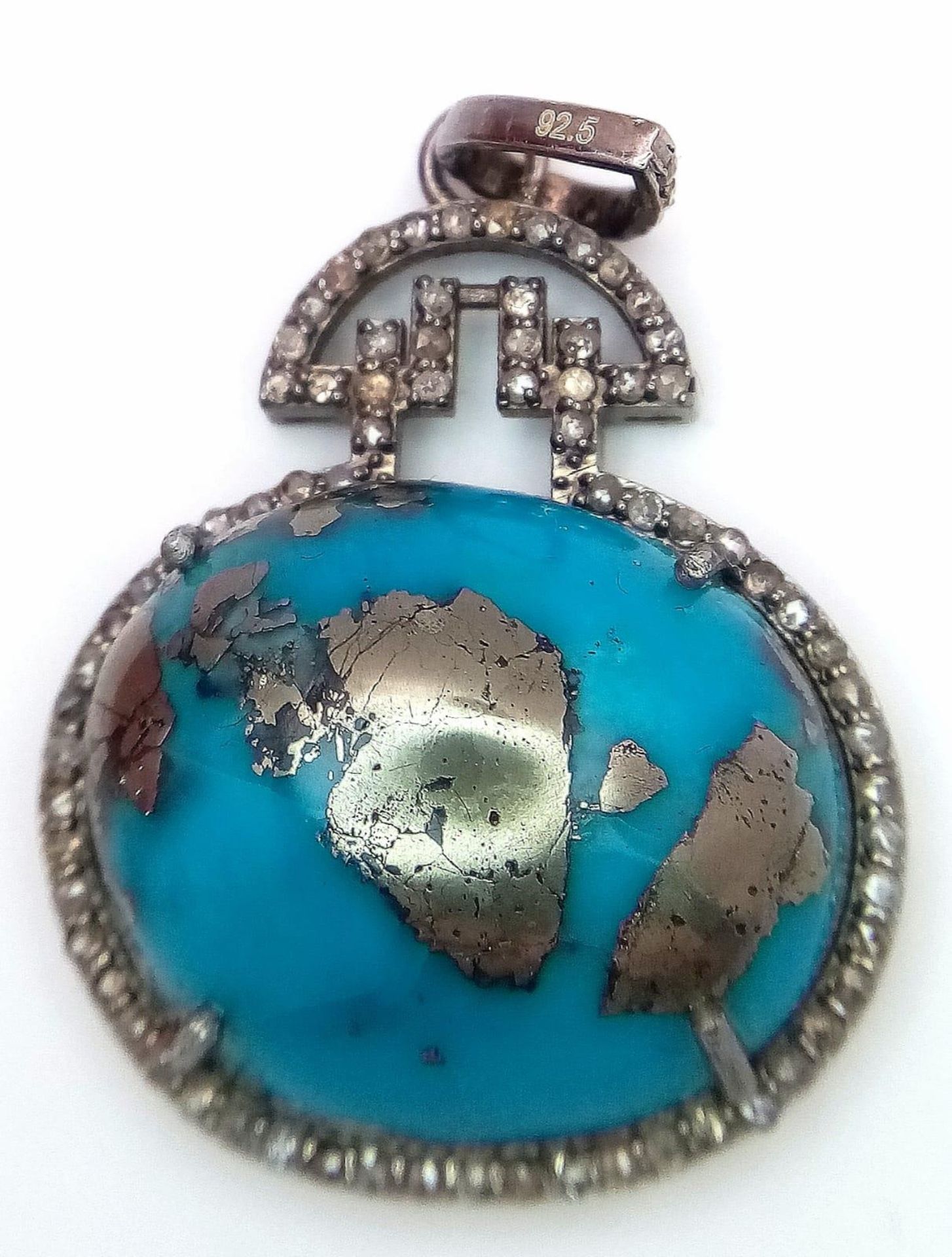 A Turquoise Cabochon and Diamond Pendant set in 925 Silver. Beautiful large cabochon with a