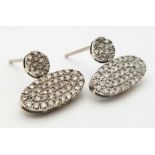 A PAIR OF DIAMOND ENCRUSTED EARRINGS SET IN PLATINUM . 2.2gms