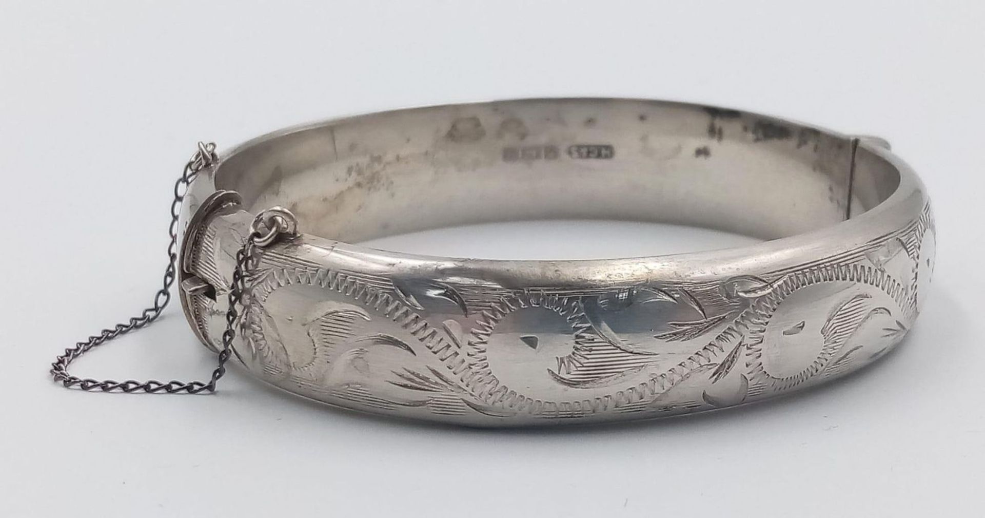 A 1994 Hallmarked Silver Scroll Detail Bangle by Henry Griffith and Sons Silversmiths. 6cm inner - Image 2 of 4