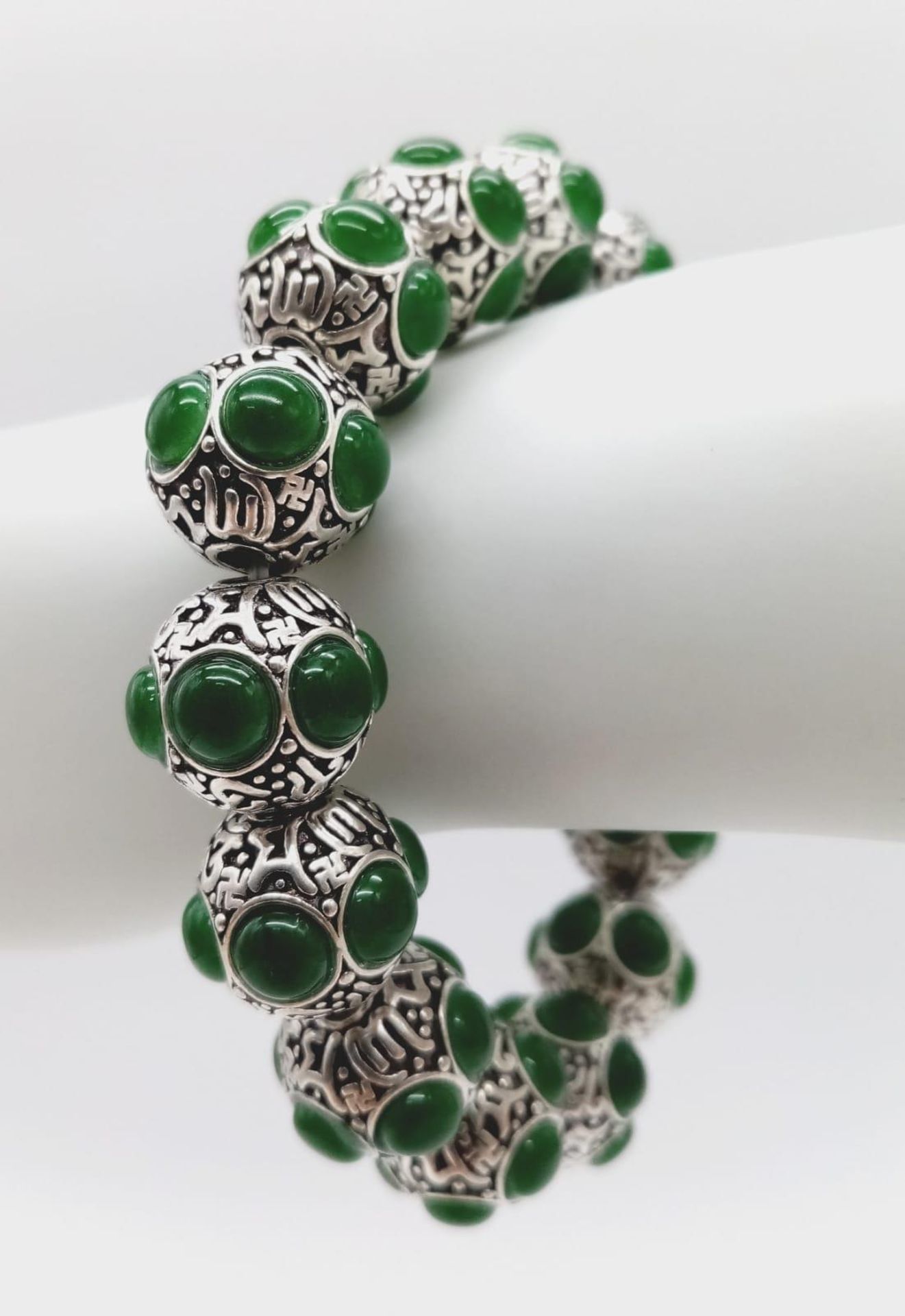 A Tibetan Silver and Green Jade Expandable Bracelet. Decorative jade cabochons and ancient Tibetan - Image 2 of 7