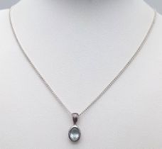 A Sterling Silver Blue Topaz Pendant on Chain. 1.8cm pendant, 46cm chain, 4.7g total weight. Ref: SC