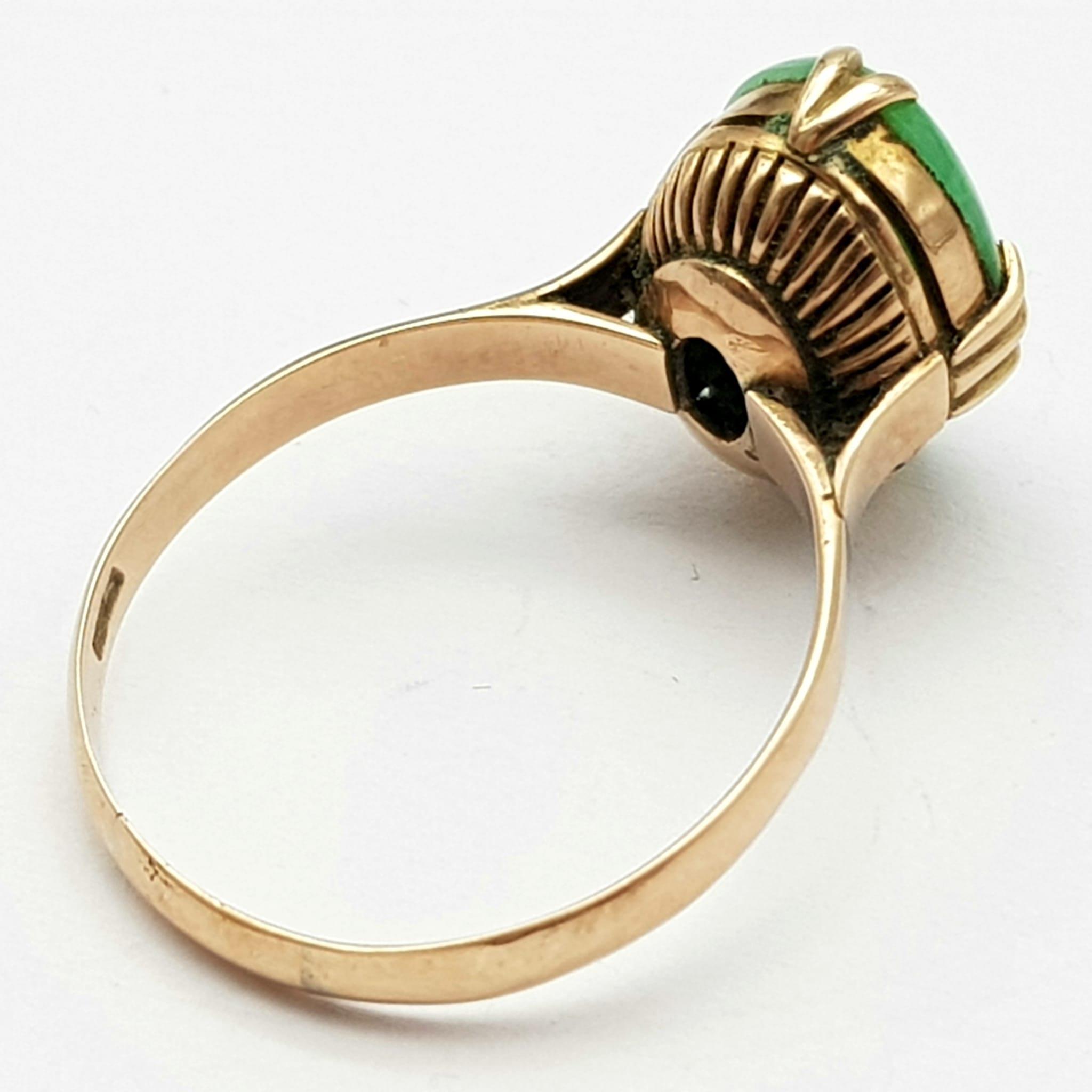 A Vintage 18K Yellow Gold Jade Ring. Oval cut jade cabochon on a four claw setting. Size R. 3.45g - Image 3 of 4