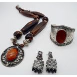 A Wonderful Trio of: Carnelian cuff bracelet, 800 German silver earrings and Berber amber resin