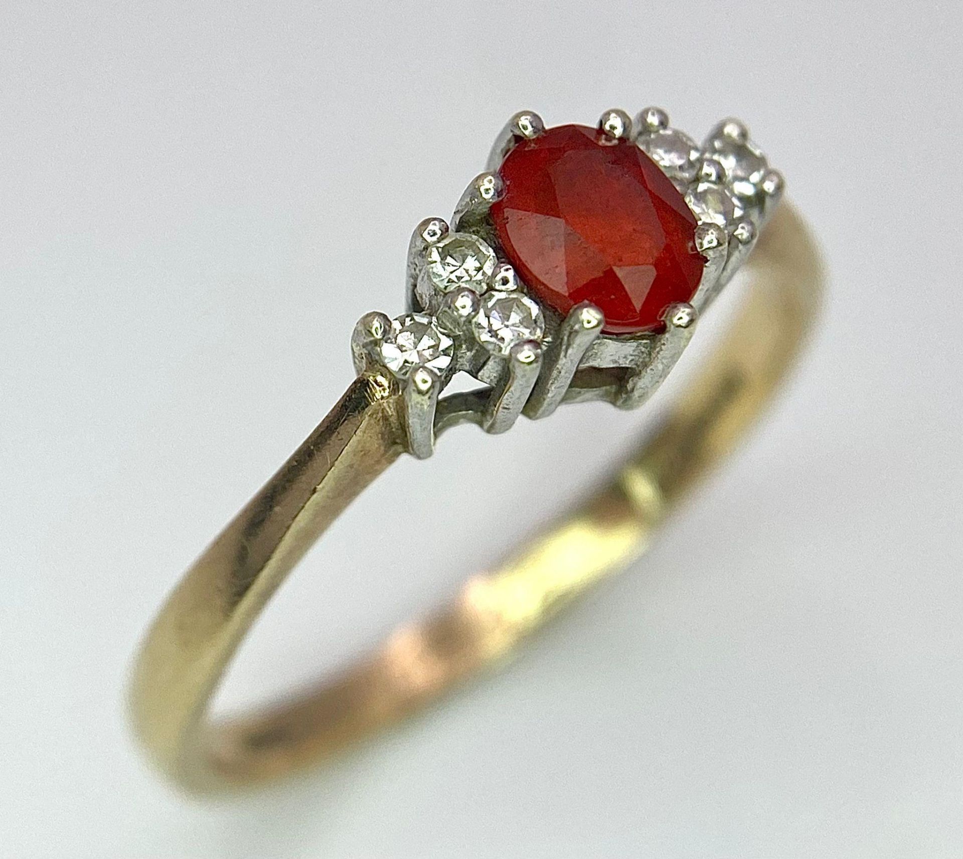 A Vintage 9K Yellow Gold, Red Sapphire and Diamond Ring. Oval sapphire with diamond accents. Size O. - Image 2 of 8