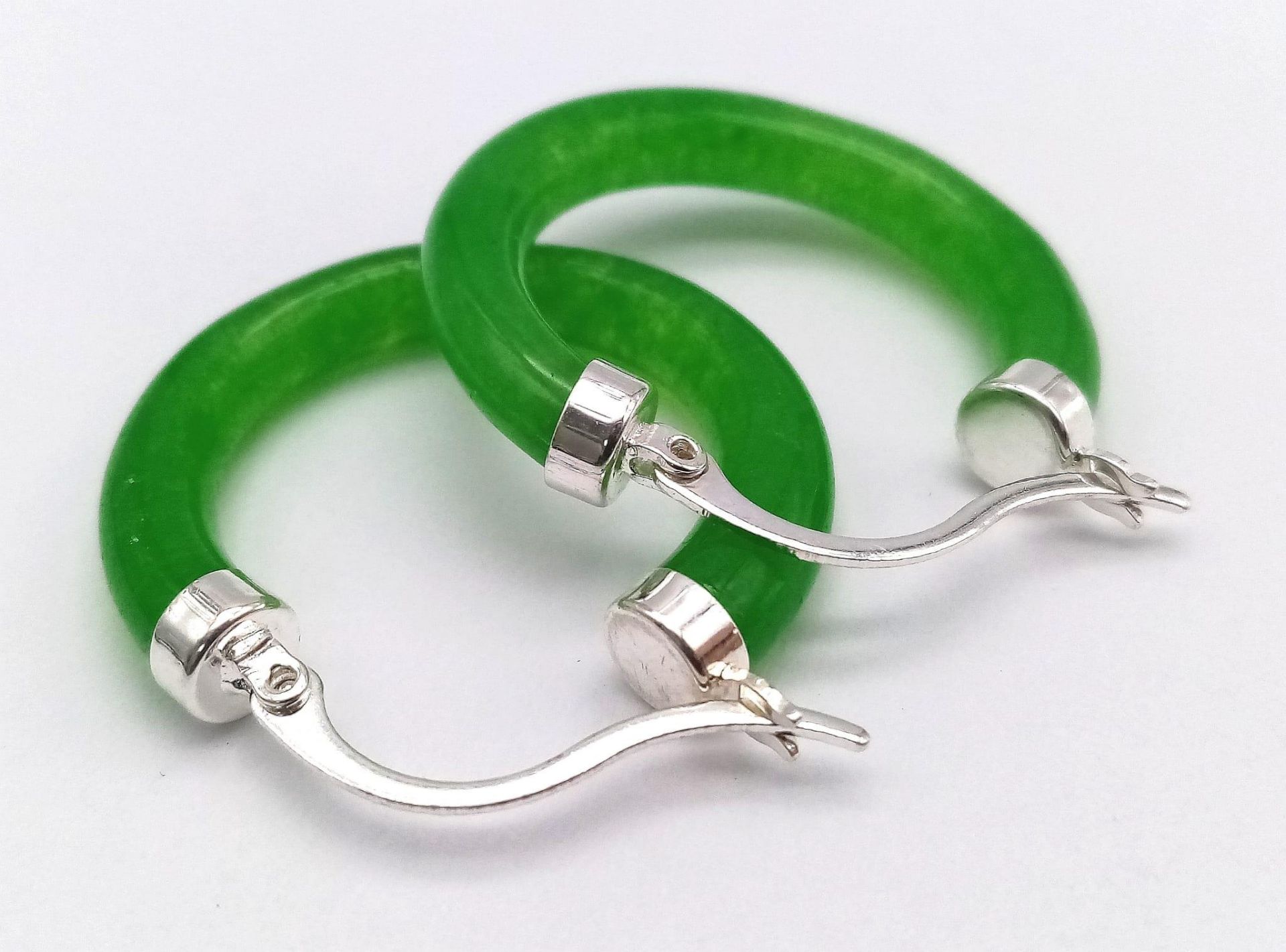 A Pair of Green Jade Hoop Earrings.