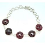 A Sterling Silver Red Stone Cabochon Set Bracelet. 19cm Length. 1.3cm Width. Gross Weight 12.75