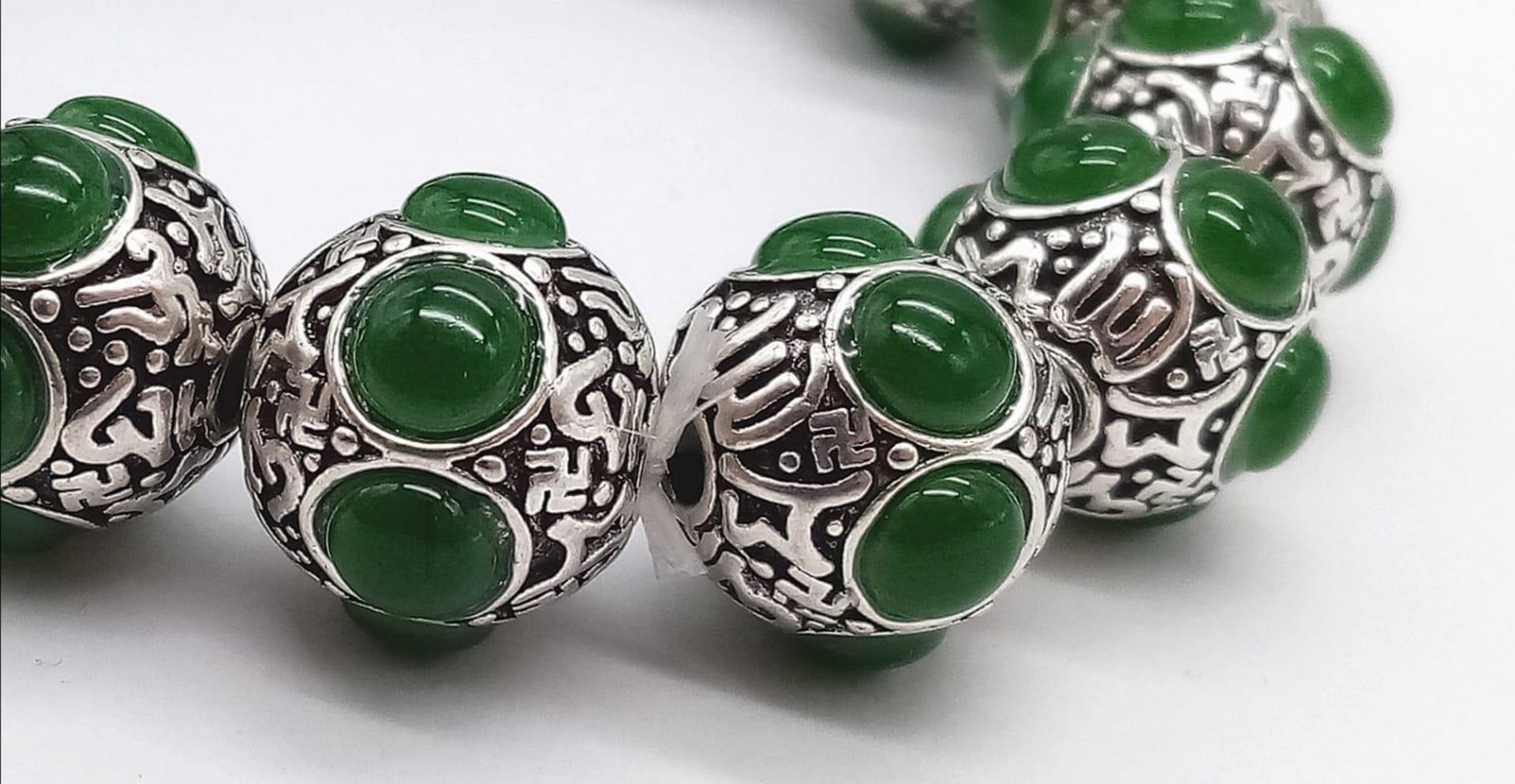 A Tibetan Silver and Green Jade Expandable Bracelet. Decorative jade cabochons and ancient Tibetan - Image 5 of 7
