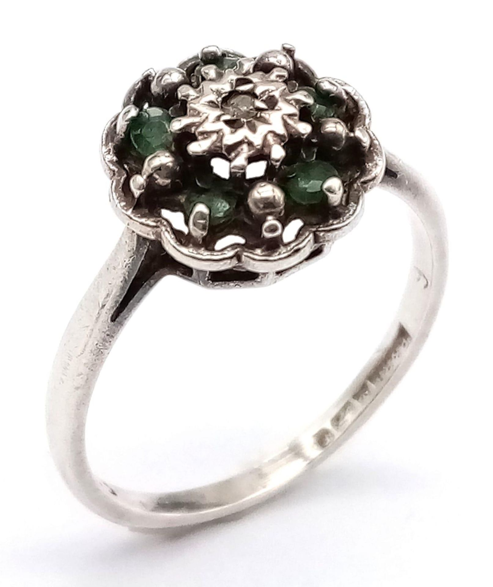 A vintage 14K white gold Emerald and Diamond floral cluster ring. Come with full Birmingham
