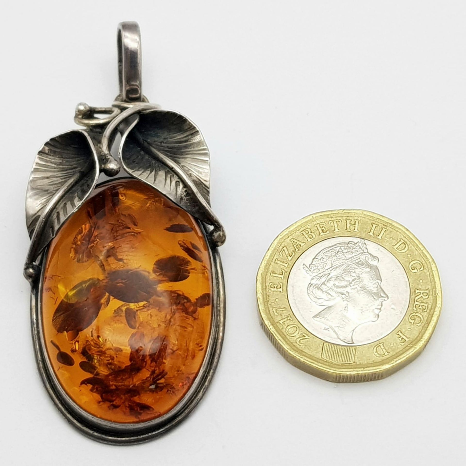 A Vintage 925 Silver and Amber Brooch. A rich amber cabochon amongst silver leaves. 6cm. 11.5g total - Image 4 of 4