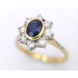 AN 18K YELLOW GOLD DIAMOND & SAPPHIRE CLUSTER RING. 0.60CTW ROUND BRIILIANT CUT DIMAONDS & 0.80CT