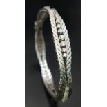 A Head-Turning 18K White Gold and Diamond Bracelet. Five waves of double-ended graduating