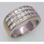 A well made 18 K yellow gold ring with three channels filled with round cut diamonds. Size: H,