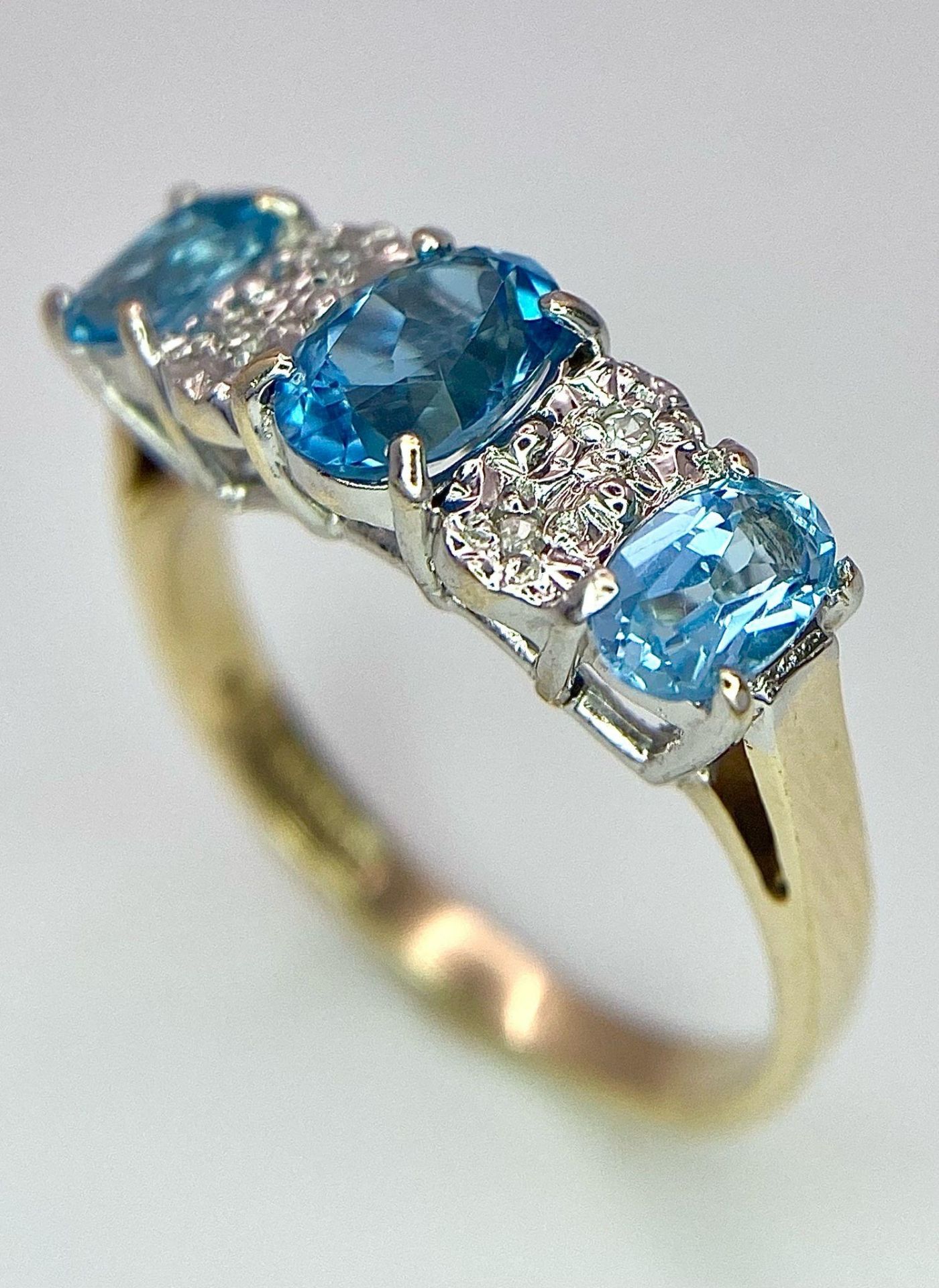 A 9K Yellow Gold Diamond and London Blue Topaz Ring. Size J, 2.1g total weight. Ref: 8410