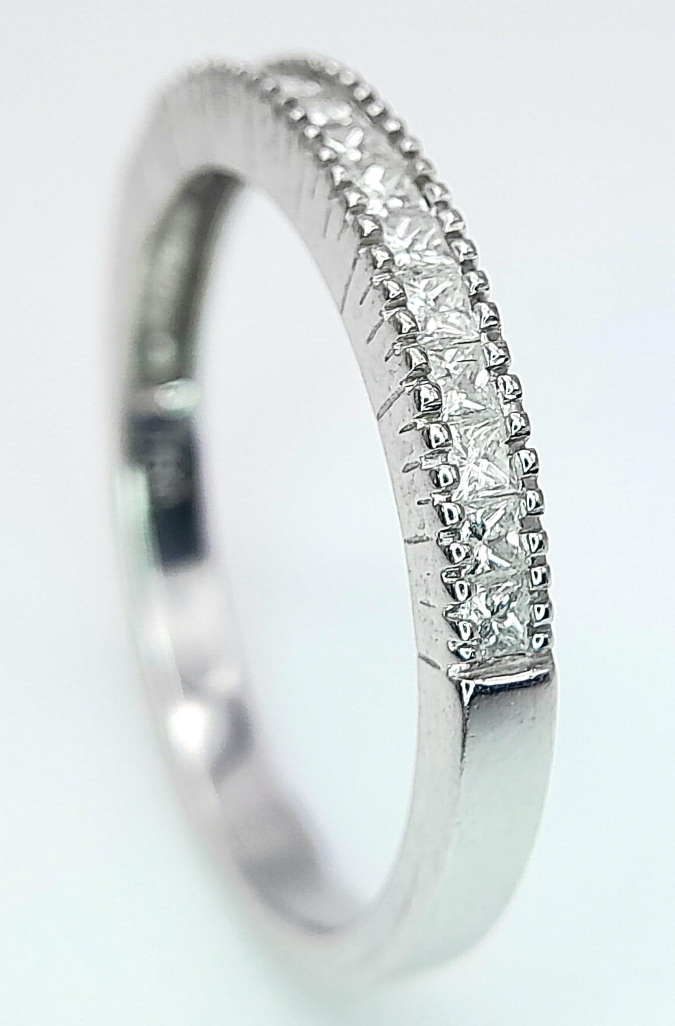 AN 18K WHITE GOLD DIAMOND SET BAND RING - PRINCESS CUTS. 0.50CTW. 2.8G. SIZE P 1/2. - Image 4 of 6