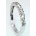 AN 18K WHITE GOLD DIAMOND SET BAND RING - PRINCESS CUTS. 0.50CTW. 2.8G. SIZE P 1/2.