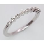 A sterling silver ring with a band of round cut cubic zirconia. Size: N1/2, weight: 1.5 g.