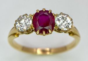 A Mesmerising 18K Yellow Gold, Ruby and Diamond Ring. A deep red oval cut ruby sits central