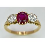 A Mesmerising 18K Yellow Gold, Ruby and Diamond Ring. A deep red oval cut ruby sits central