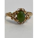 9 carat YELLOW GOLD and JADE RING . Having an oval Jade gemstone set to top in attractive baroque