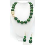 An excellent quality, large beaded (20 mm diameter), spinach green jade necklace and earrings set