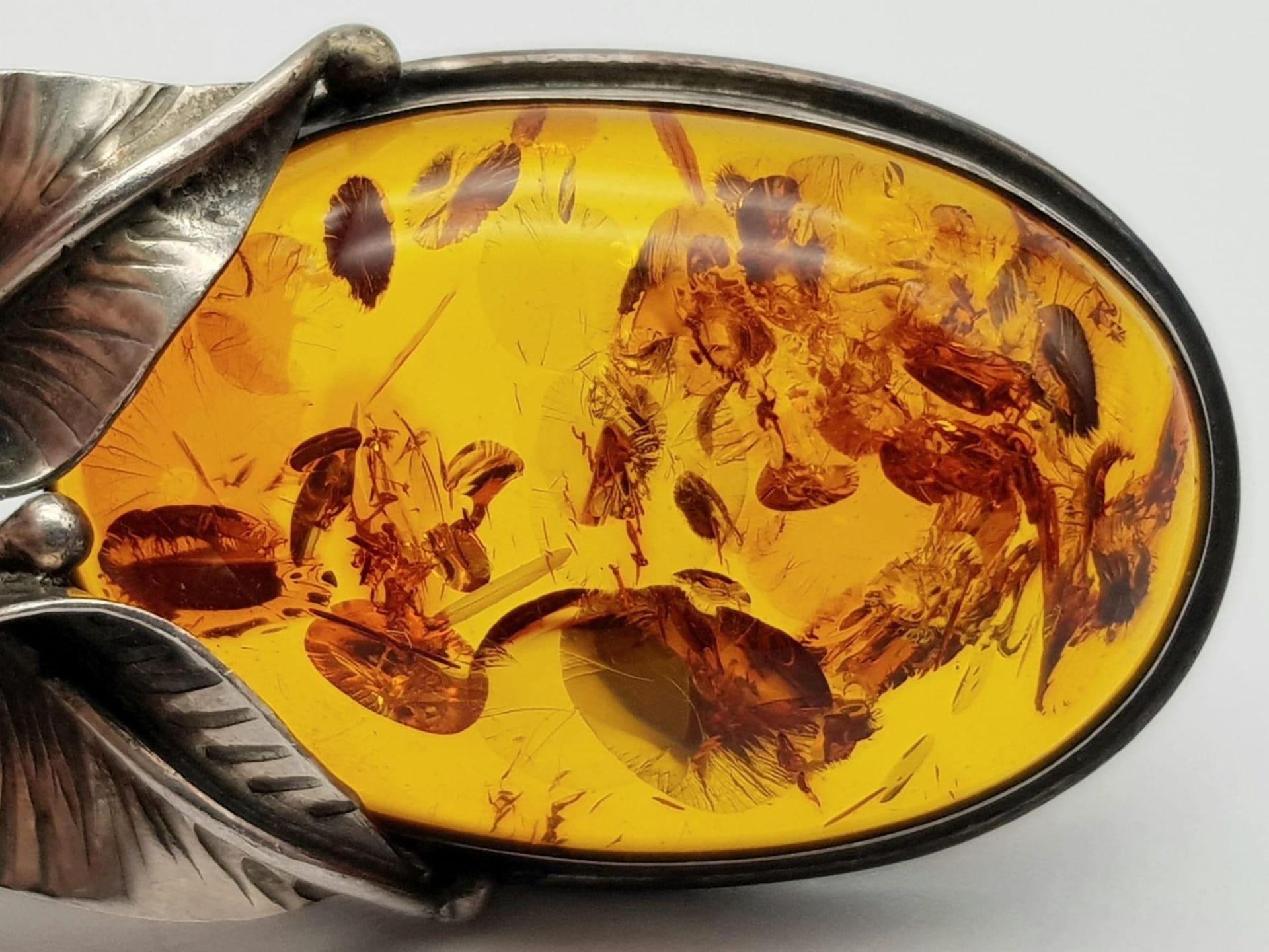 A Vintage 925 Silver and Amber Brooch. A rich amber cabochon amongst silver leaves. 6cm. 11.5g total - Image 3 of 4