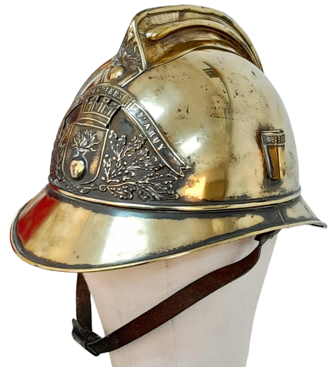A Late 19th Century French Fireman's Brass Ornate Helmet. With original liner.