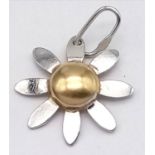 A fancy 9K yellow and white gold flower pendant. Total weight 0.3G.