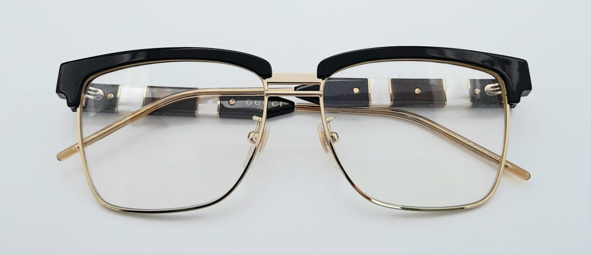 A GUCCI pair of glasses, gold plated in parts with mother of pearl highlights. Very stylish!
