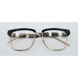 A GUCCI pair of glasses, gold plated in parts with mother of pearl highlights. Very stylish!