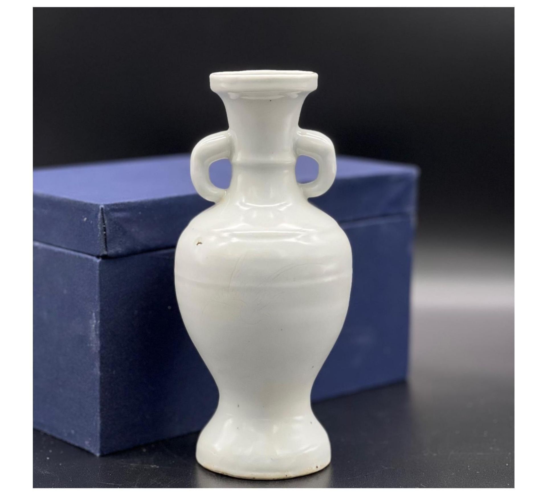 A “sweet white” glazed two-handled vase with flower and bird pattern, Late Ming Dynasty. Minor