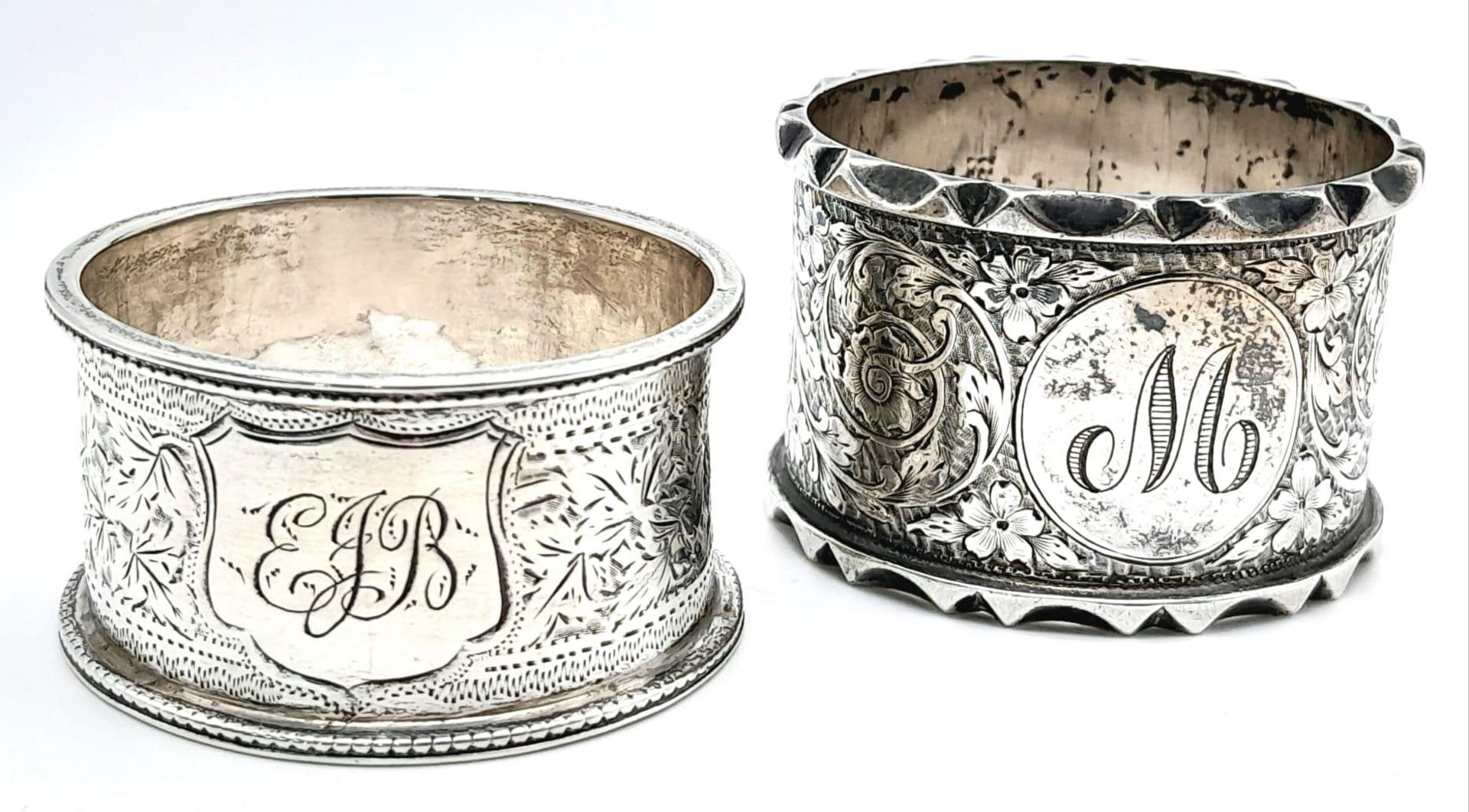 A collection of 2 antique sterling silver napkin holders with fabulous floral engravings. Come